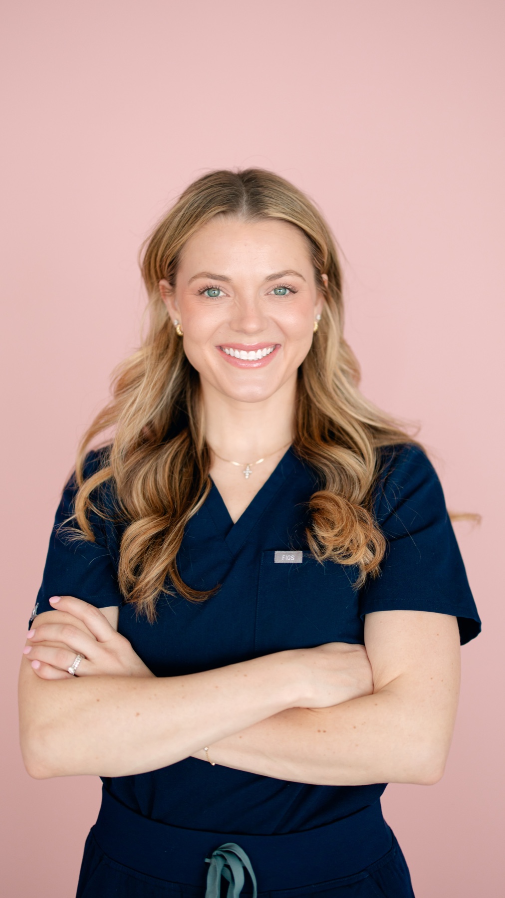 Channing Stewart, Doctor of Physical Therapy, smiling in navy scrubs